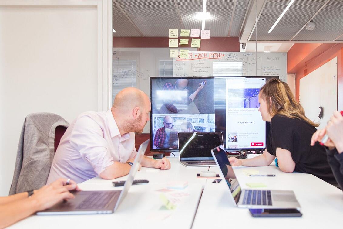 Photo: A user test at Fraktio’s office. The facilitator is in a separate room dedicated to user testing with the user while the rest of the team observes the situation via video and takes notes.